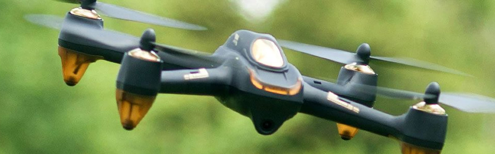 Remote control drone in flight with green background